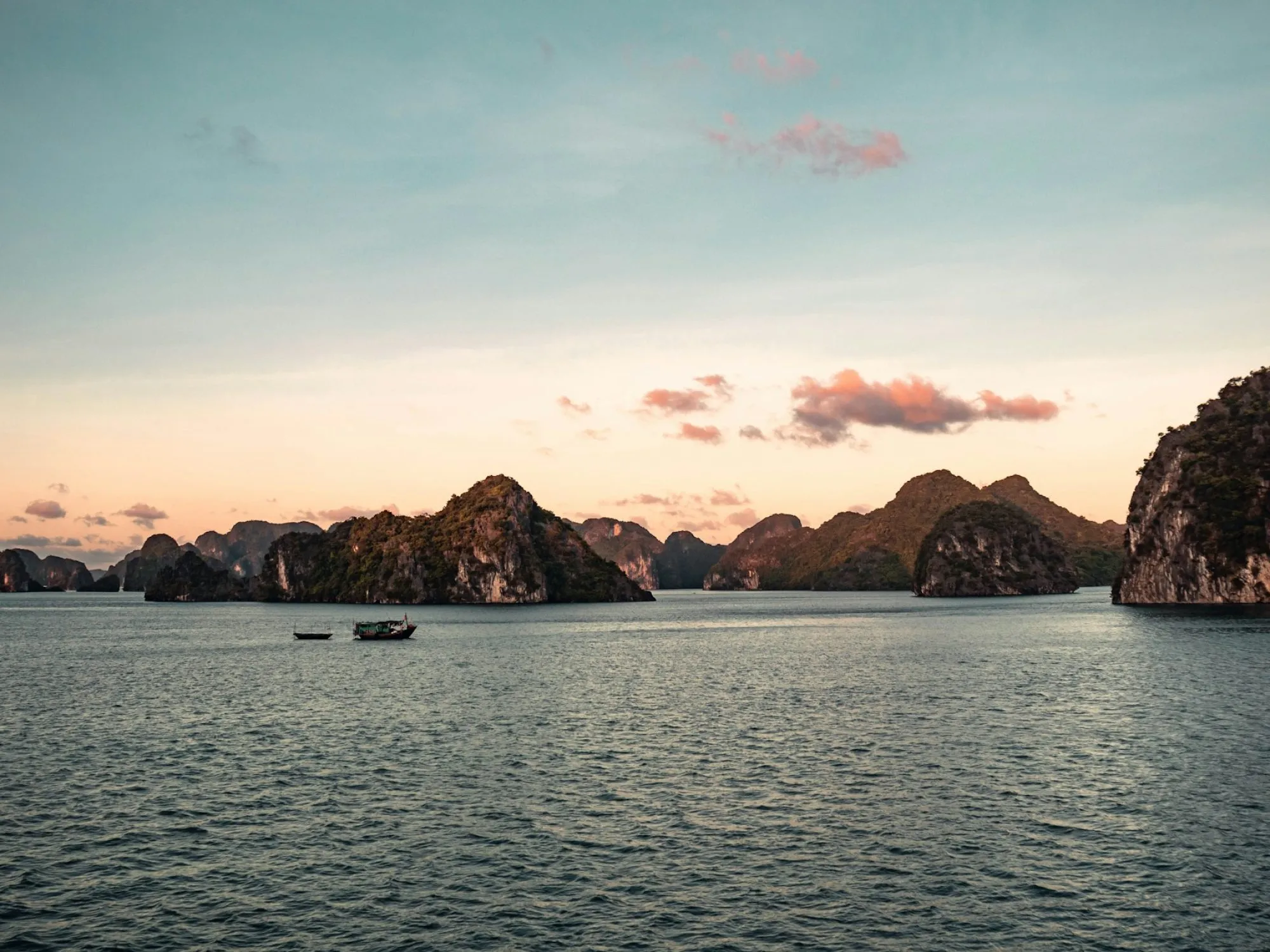a group of small boats floating on top of a large body of water