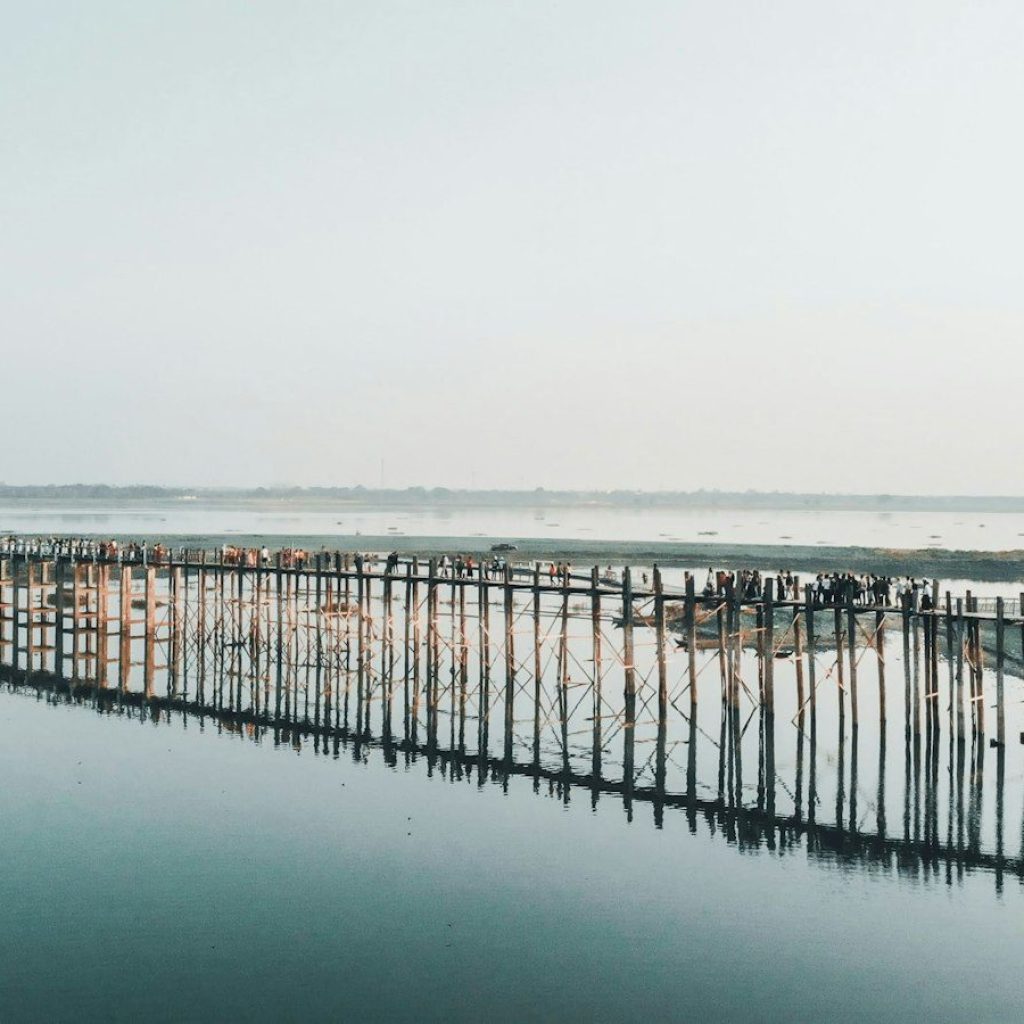 brown wooden dock on sea under white sky during daytime