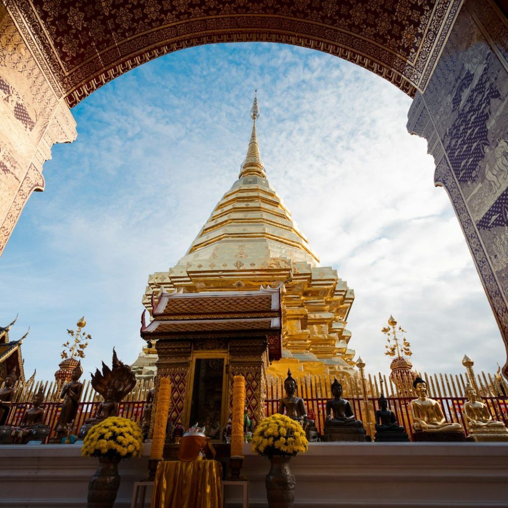 An arch leading into a temple with a sky in the background