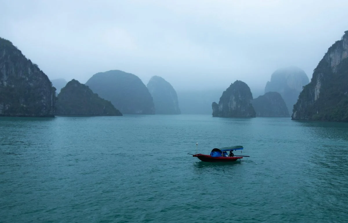 blue and red boat on body of water