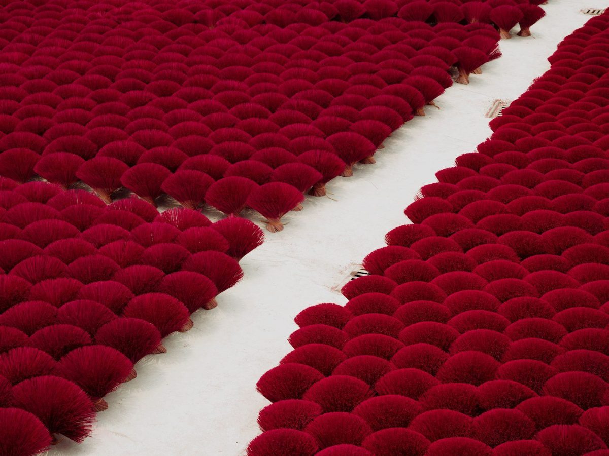 a large number of red balls on a white floor