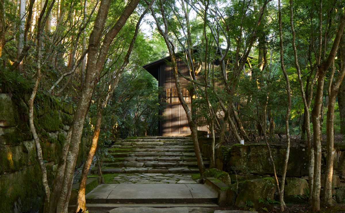 Stone steps through the forest garden to a latticed pavilion at Aman Kyoto