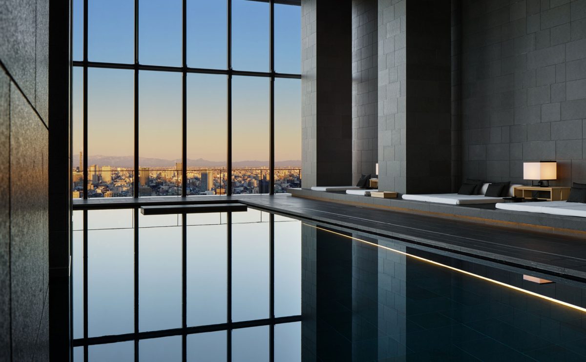 Aman Tokyo's 30-meter indoor pool with the city skyline through floor-to-ceiling windows