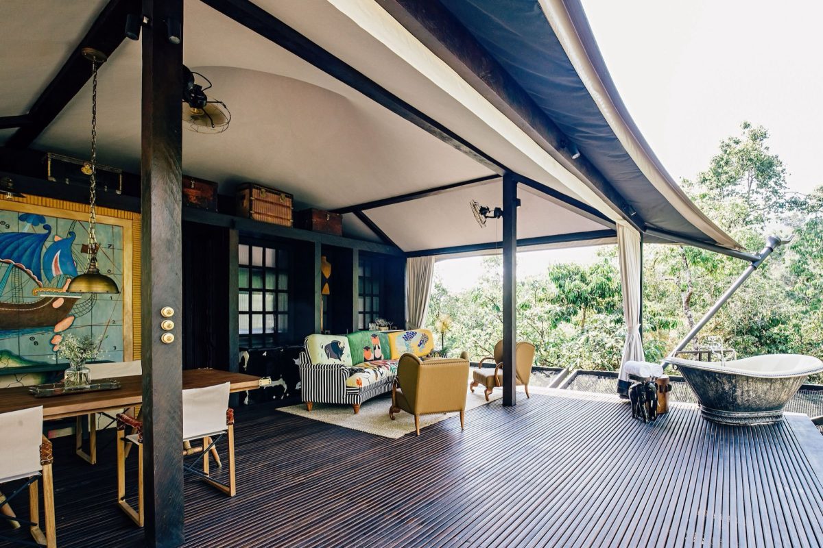 Open-sided Bensley tent at Shinta Mani Wild with a bathtub on the deck above the Cardamom rainforest