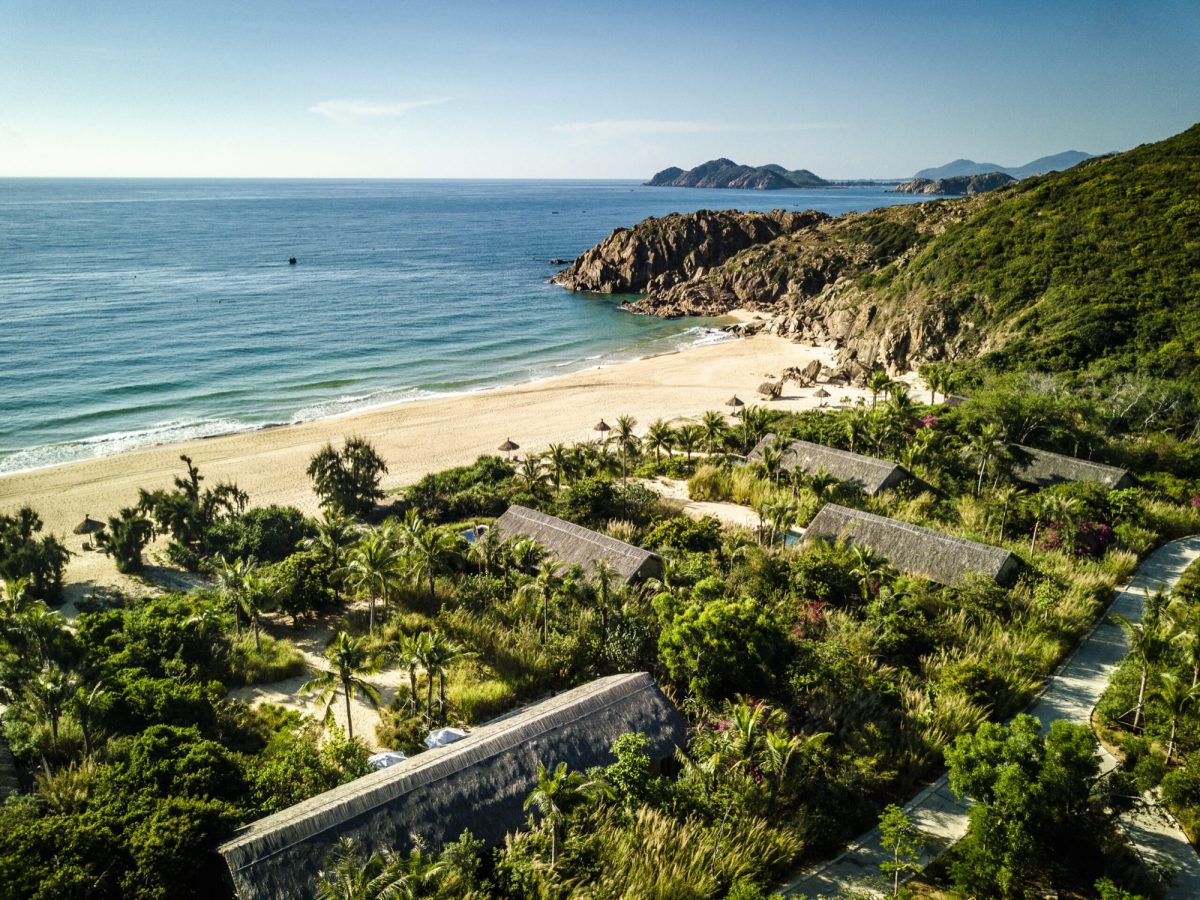 Beach Pool Villa exterior at Zannier Bai San Ho, Vietnam, with thatched roof and sea beyond